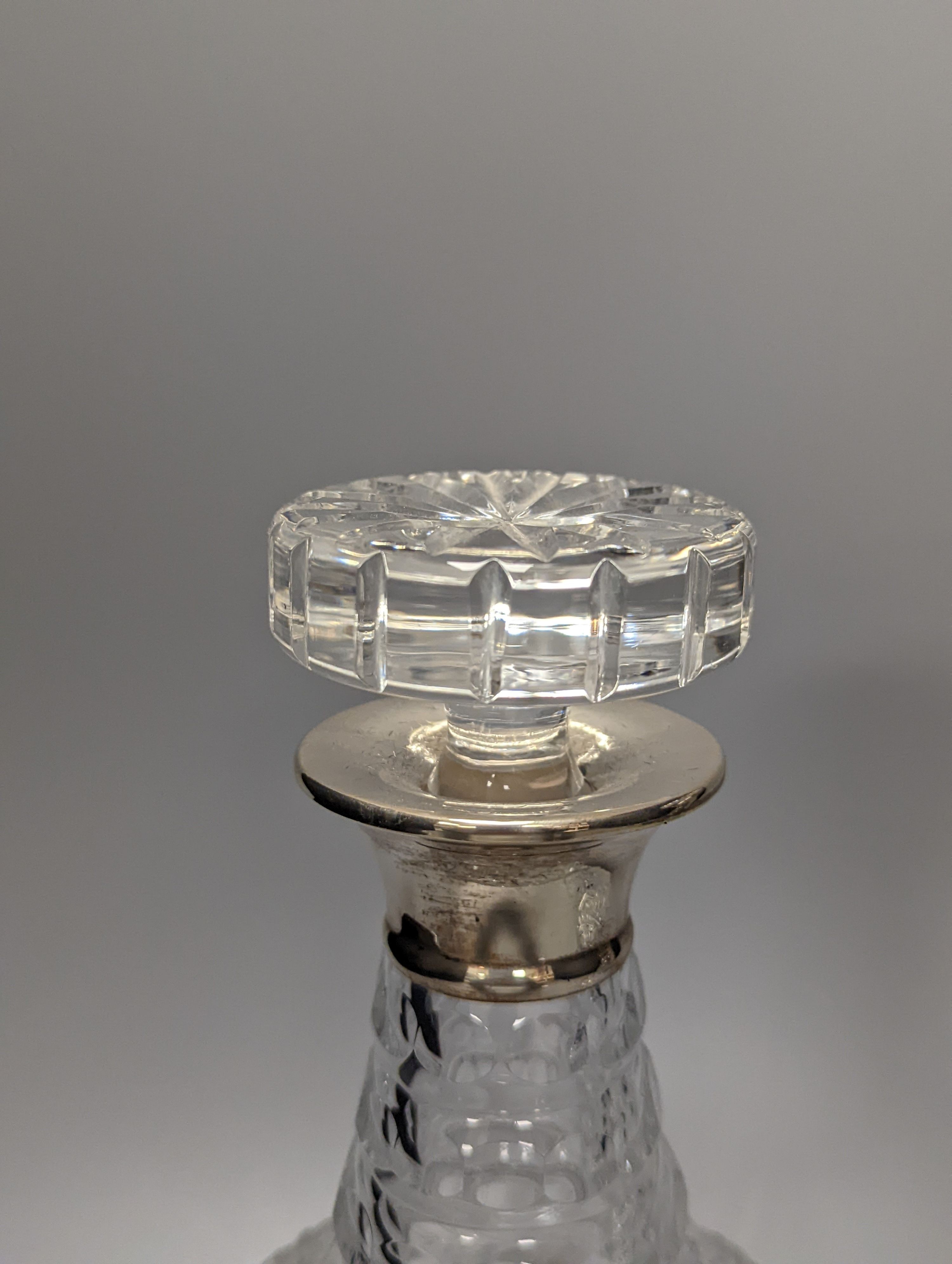 A pair of silver mounted glass decanters, with stoppers, height 28cm